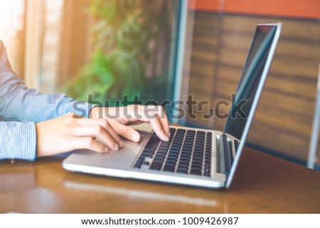 Woman hand working on laptop in the office.