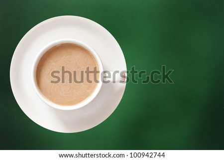 A cup of coffee on green background
