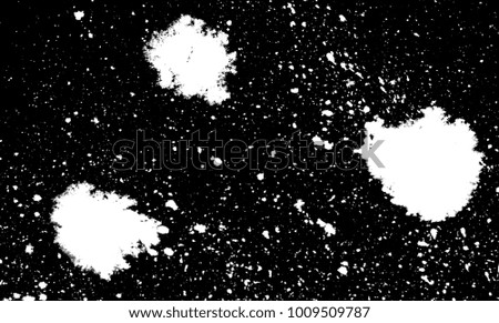 white splashes of spots on a black background