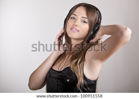 A Beautiful and cheerful young woman enjoying music
