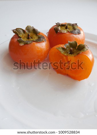 Persimmon on a white plate.