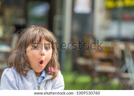 Amazement face expression of a young girl.
