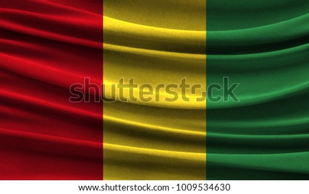 Realistic flag of Guinea on the wavy surface of fabric