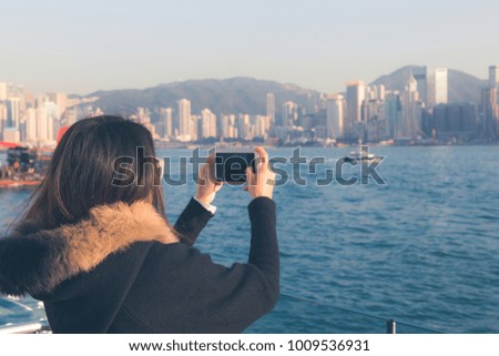 Asian girl traveler visiting in Hong Kong Harbour, located along the Victoria Harbour in Hong Kong.