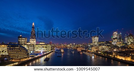 London skyline on Thames river at dusk.