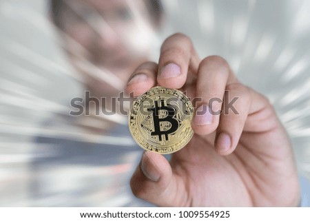 Golden bitcoin in hand's man with exprosure effect background.