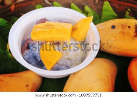 close-up image of "chiang mai" mango sticky rice in paper bowl 
