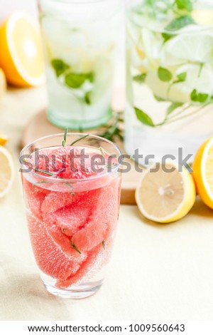 A glass of lemonade with grape seed slices, soda water and lemon juice. Shooting in a high key.