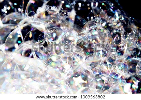 Soap background / A soap bubble is an extremely thin film of soapy water enclosing air that forms a hollow sphere with an iridescent surface.