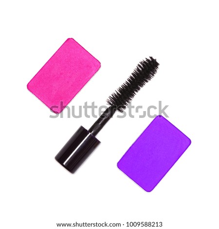 Close-up of fuchsia and violet colored eyeshadow with black mascara on white background. Trendy makeup