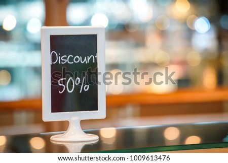 discount 50% on the black board standy in the bakery shop. Beautiful Blurry and bokeh background