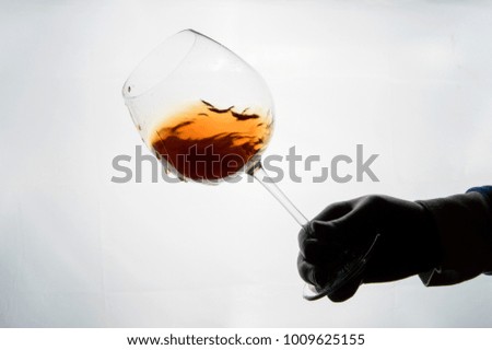 Hand is holding glass of wine