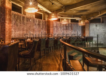 Loft style decorated restaurant-bar interior photo Royalty-Free Stock Photo #1009631527