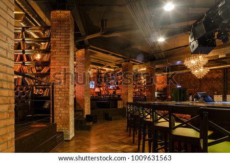 Loft style decorated restaurant-bar interior photo Royalty-Free Stock Photo #1009631563
