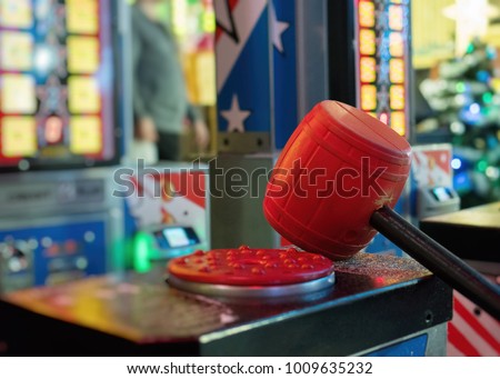 Test your strength hammer game in theme park. Royalty-Free Stock Photo #1009635232