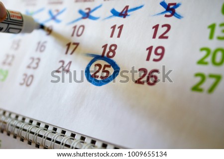 On the wall calendar, the marker marks important dates, deadline