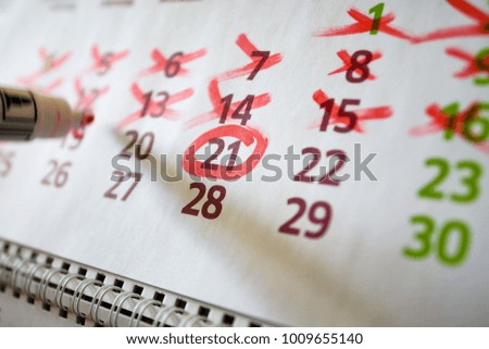 On the wall calendar, the marker marks important dates, deadline
