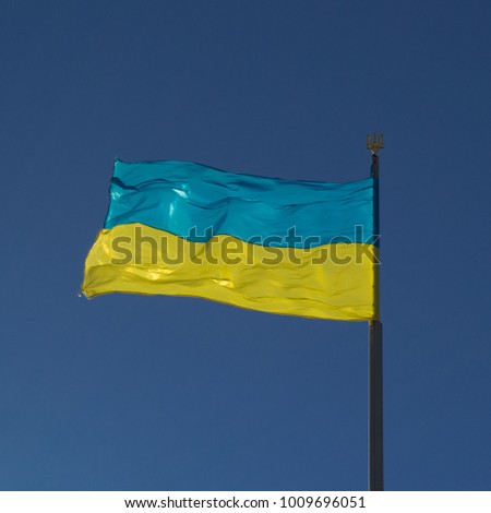 Ukrainian flag in the wind on a heavenly background