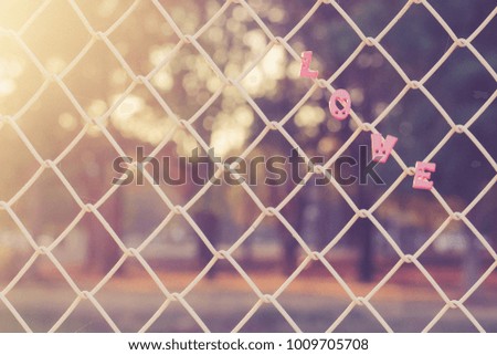 metal net and love text background, copy space , sunlight background, romantic background