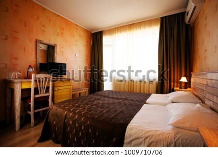 Warm colored light in bedroom at hotel Royalty-Free Stock Photo #1009710706