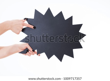 Hands holding black figured chalkboard on white background, nails black