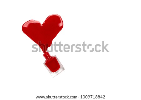 Red nail polish spilled heart shape isolated on white background. Valentine's Day.