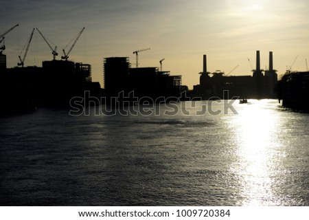 Silhouette of River Thames and Battersea power station in the distance before sunset. London, England, United Kingdom