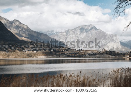 view of lake with on the background a small village of Lombardy - Italy