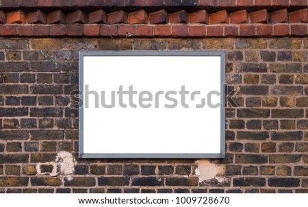 Blank advertising poster billboard on rough brick wall