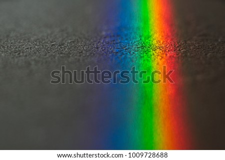 Close up macro photo of so beautiful rainbow glare spectrum lighting specular reflection on the floor. Sun ray shining through window glass that work as prism and reflex colorful spectrum on floor.
