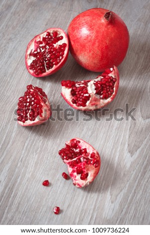 Slices of ripe pomegranate on a wooden table