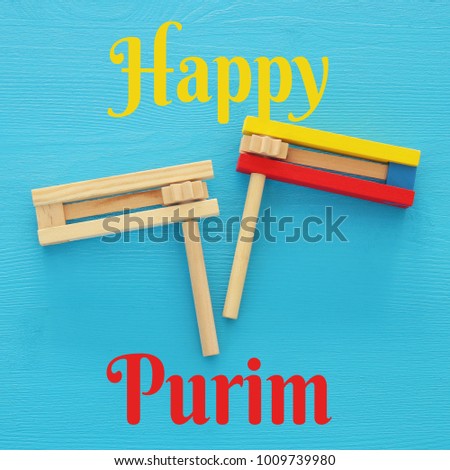 Purim celebration concept (jewish carnival holiday). Top view of noise maker traditional toy