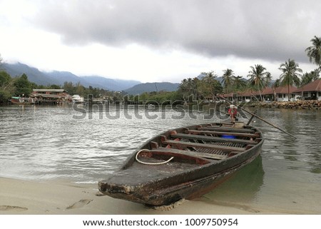 Long tail boat stop on the beach in Koh Chang Island, Thailand. 