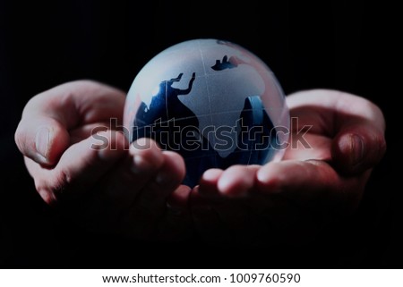glass globe in hand.