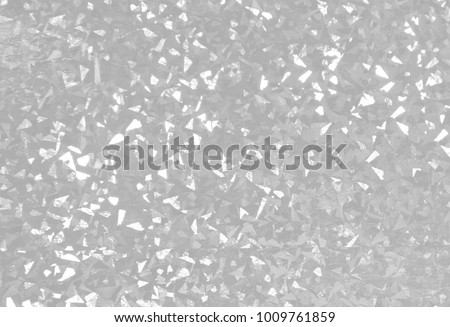 White texture of foil with holographic effect. Grayscale holographic foil background. Holographic foil reflection. Confetti in air pattern.  Royalty-Free Stock Photo #1009761859