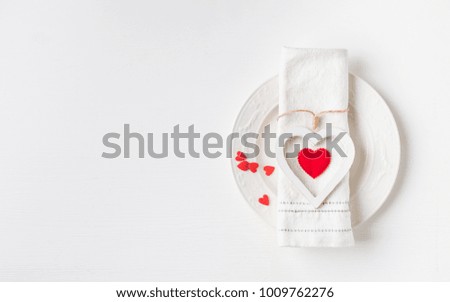 Valentines day meal background with white wood vintage heart  and red candy hearts, white plate and napkin. Romantic holiday table setting. Beautiful background with blank. Restaurant concept.Flat lay