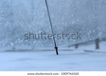 Background texture of snow flakes over clear white plastic umbrella