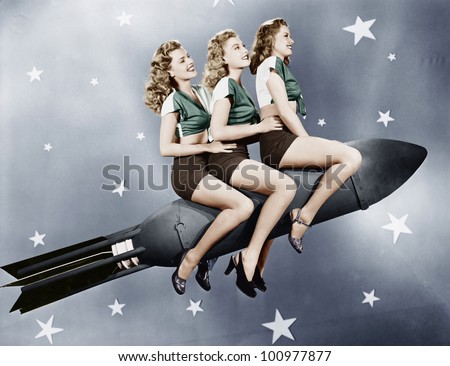 Three women sitting on a rocket Royalty-Free Stock Photo #100977877