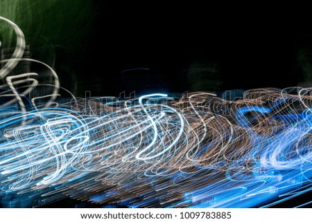 Motion blur colorful background of display lights infront of the shopping mall. Multicolored striped lines in motion made from  lighting effect ,Light trails over black long exposure shot concept