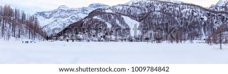 mountain village nestled in the snow, in winter