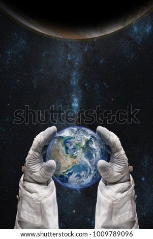 Earth in the hands of astronaut. Earth Day concept. Elements of this image furnished by NASA.