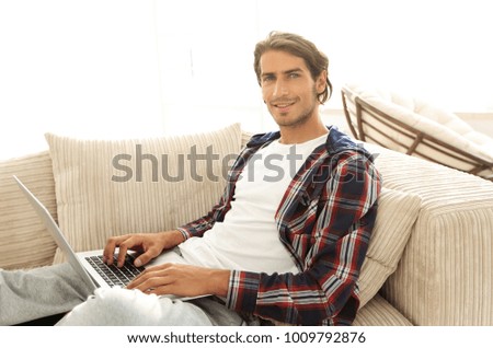 serious young man with laptop.