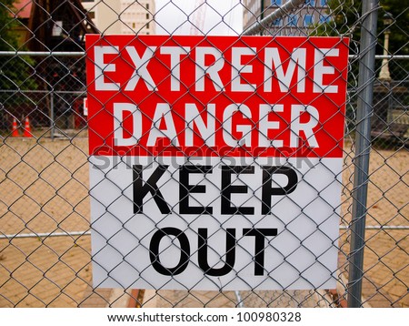 warning sign posted on the fence