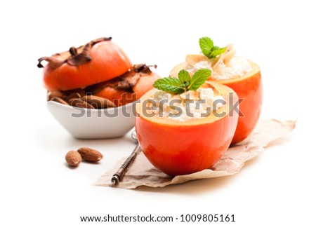 Sweet  persimmons stuffed with cottage cheese
and almonds isolated on white 