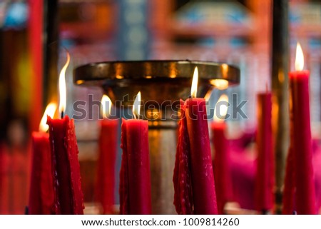 Red candles and flame with the blur background in Chinese temple for people come for praying