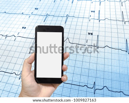 Mock up image of hand holding black smartphone with blank white screen on endocardiogram background. Concept for display your design. 