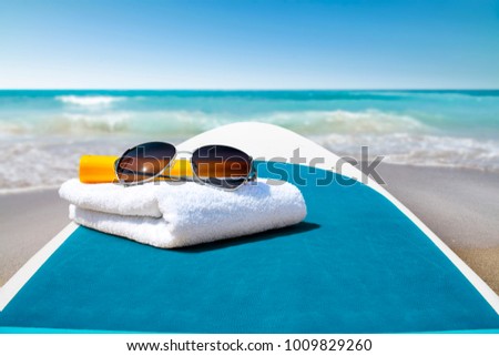 Surfboard and summer time on beach. Free space for your decoration. 