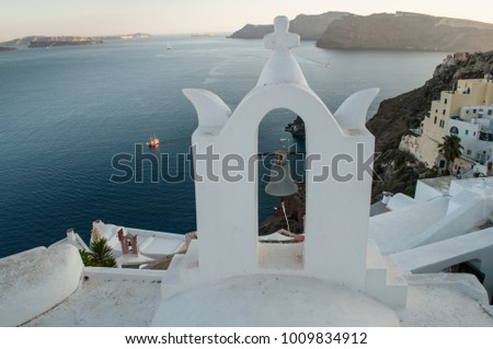 Bell towers and traditional white houses in Santorini Island, Cyclades, Greece 