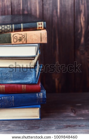 Old books on wooden background. The source of information. Books indoor. Home library. Knowledge is power
