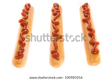 A picture of three single sausages with a ketchup line